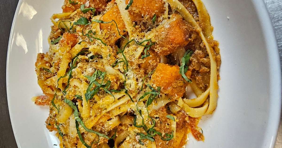 A bowl of pasta with cheese and vegetables at BC's Kitchen
