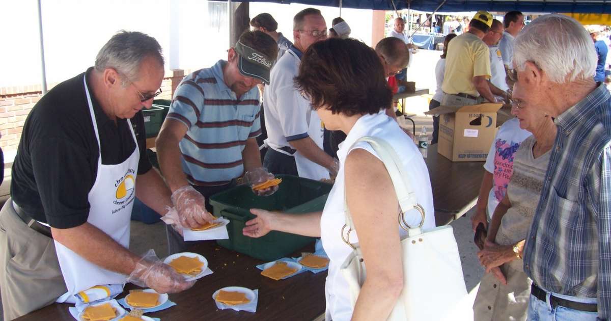 Visitors trying out cheese at the Arthur Amish Country Cheese Festival