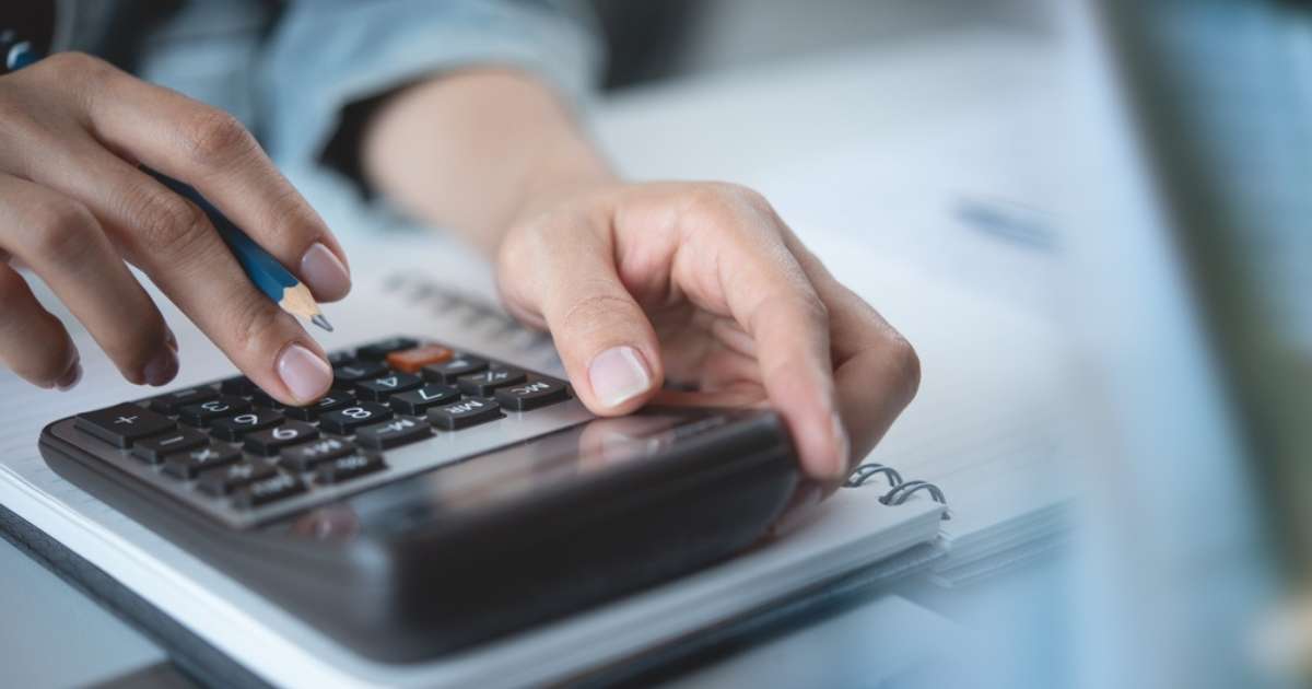 A person utilizing a calculator for calculations, showcasing the application of technology in everyday mathematical tasks.